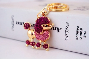 Detailed view of pink crystal poodle keychain with sparkling rhinestones and gold hardware