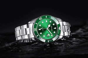 Detail of green quartz watch dial with calendar window and splash water effect