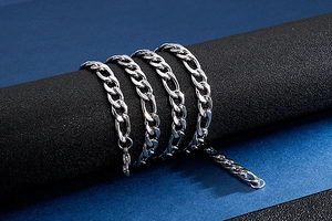 Detailed view of silver stainless steel curb chain wrapped on a professional display stand