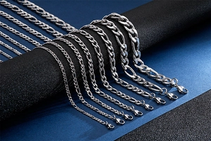 Macro view of silver stainless steel NK chain necklaces showing various widths on a display