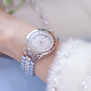 Macro shot of silver luxury women's watch featuring full sparkling rhinestone embellishment