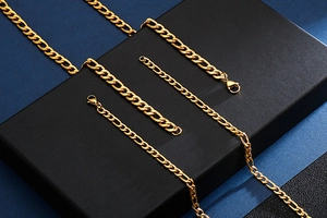 Detailed view of 18K gold plated stainless steel Figaro chains with lobster clasps