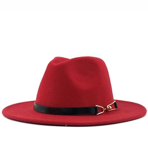 Detailed shot of red wool fedora hat with black leather band and gold buckle detail