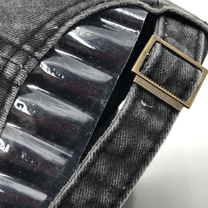 Detail of adjustable metal buckle on dark grey washed denim baseball cap with clean stitching