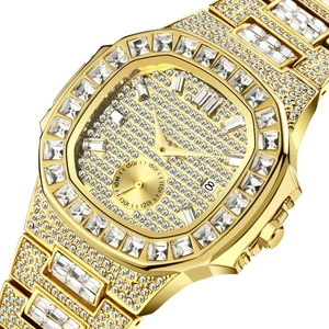 Close-up of luxury gold iced-out watch with crystal-encrusted band and date display