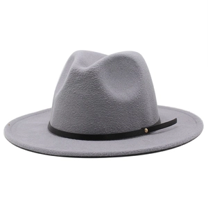 Detail view of the gray fedora hat with a black leather band and golden metal stud