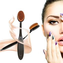 Detail of oval makeup brushes with black handles next to a model with artistic makeup