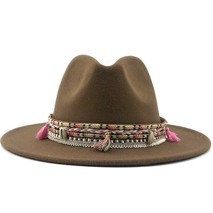 Detail of coffee fedora with bohemian braided bands, colorful tassels and seashell accents