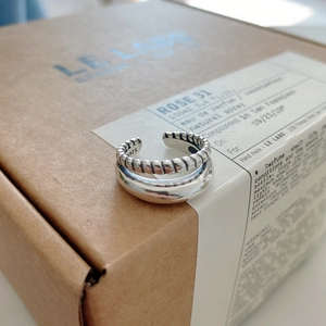 Detailed macro view of S925 sterling silver double-layered twisted rope and smooth ring