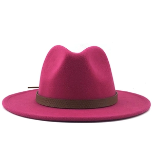 Detail van rozerode wollen fedora hoed met een brede platte rand en bruine leren band