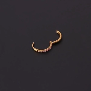 Golden hinged hoop earring with pink zircons shown in open position on dark background
