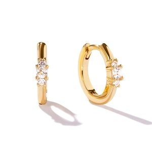 Polished gold round huggie hoop earrings featuring three sparkling zircon stones