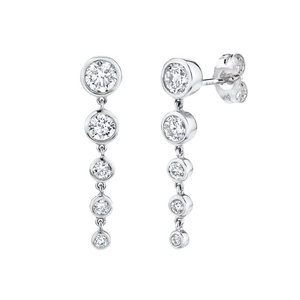 Detail of silver-tone drop earrings featuring five graduated bezel-set round zircons
