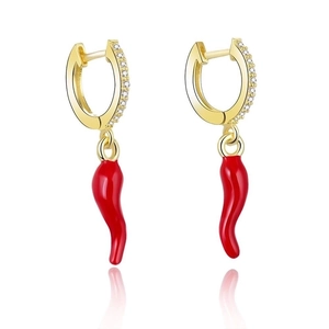Detailed close-up of golden chili earrings with red enamel charms and inlaid crystal accents