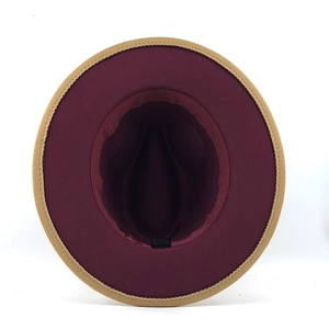 Detailed top view of a two-tone fedora hat showing burgundy interior and camel brim