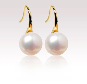 Detailed close-up of white round freshwater pearls on long gold-plated silver hooks
