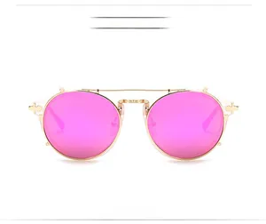 Macro detail of KDEAM pink mirror lenses and golden metal frame with cross-shaped ornament