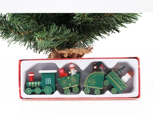 Detailed view of green wooden Christmas train with snowman and bear in a gift box