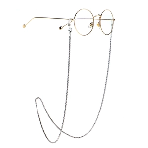 Silver stainless steel box chain glasses strap with round gold frames on white background