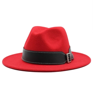 Detail of red wide brim fedora with black leather band and silver buckle accent
