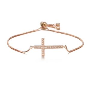 Detail of rose gold adjustable bracelet with micro-paved cubic zirconia cross charm