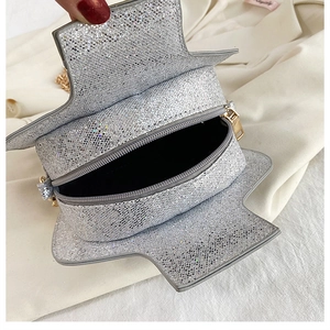 Macro view of silver sequin wine bottle bag showing metal zipper and black lining