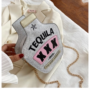 Detail of silver sequin wine bottle crossbody bag with Tequila embroidery and gold chain