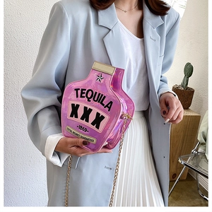 Pink holographic tequila bottle crossbody bag with gold chain strap on model