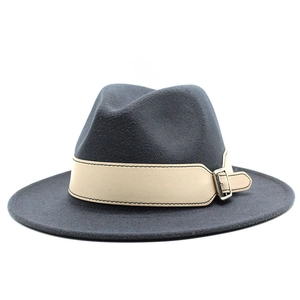 Detail of dark grey wool fedora hat with a beige contrast band and adjustable metal buckle