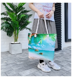 Detail view of tropical beach print tote bag with thick cotton rope handles and metal eyelets