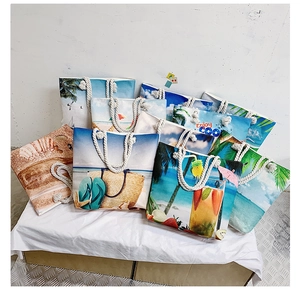 Close-up of beach canvas tote bags with tropical prints and woven rope handles
