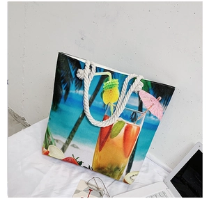 Detail of canvas beach tote with tropical prints and white nautical rope handles