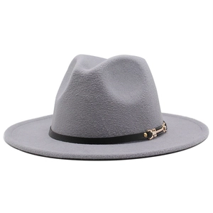 Detail of grey wool fedora hat with a black leather band and golden buckle closure