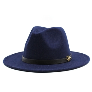 Detail of dark blue wool fedora hat featuring black leather band and gold M buckle