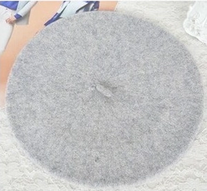 Detailed top view of a grey wool octagonal beret hat with soft felt texture fabric