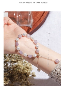 Detail of freshwater pearls and purple crystals bracelet with gold adjustable chain