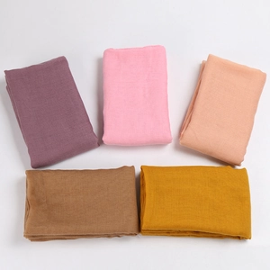 Detail shot of lightweight candy-colored voile scarves with breathable linen texture