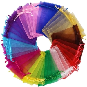 Detailed overhead view of assorted colorful organza drawstring gift bags in a circular layout
