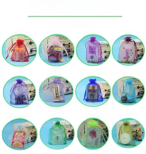 Detail of 12 organza drawstring bags in various colors for jewelry and gift packaging