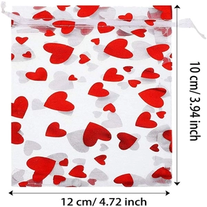 Detailed view of white organza gift bag with red hearts and size 10x12cm markings