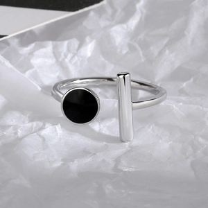 Minimalist silver open ring featuring a black round enamel element and a geometric bar
