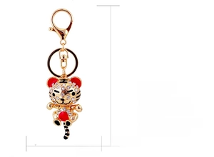 Macro view of crystal zodiac tiger keychain with golden lobster clasp and dimensions