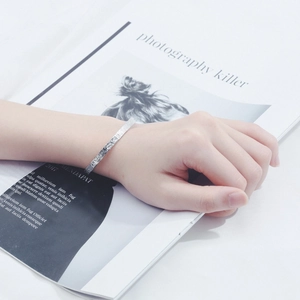 Minimalist silver open bangle for women with textured metal finish shown on wrist