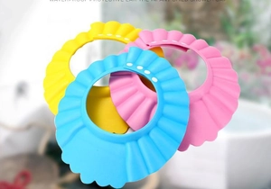 Detail of adjustable baby shower caps with ear protection in yellow blue and pink colors