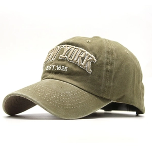 Close-up of NEW YORK embroidery on vintage army green washed cotton baseball cap