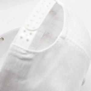 Detail of adjustable white snapback closure and fine stitching on twill baseball cap