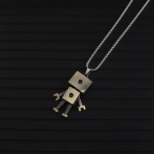 Detail of vintage bronze robot pendant with movable limbs on a silver box chain necklace