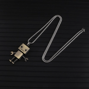 Detailed shot of bronze robot pendant with movable limbs on a silver link chain necklace