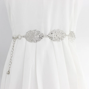 Silver hollow leaf metal waist chain belt on white dress for women accessories