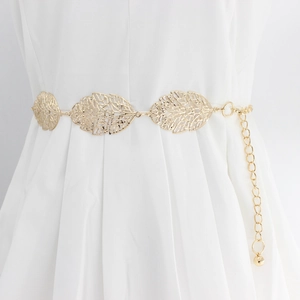 Elegant gold metal leaf hollow waist chain displayed on a white dress for women